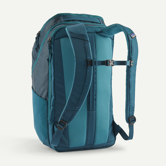 Back view of the Black Hole Pack 32L backpack in teal, showcasing padded shoulder straps and breathable mesh back panel.