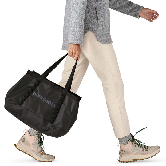 Black Hole Tote 25L, lightweight recycled polyester, durable, water-repellent, Fair Trade Certified, versatile travel accessory.