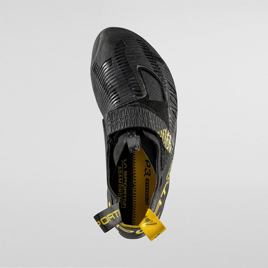 Ondra Comp climbing shoe with SenseGrip™ technology, black with yellow accents, top view.