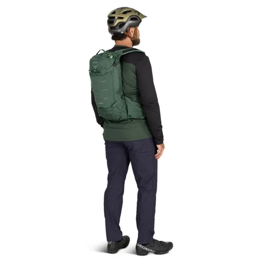 Detailed view of a person wearing the Raptor 10 hydration backpack for mountain biking, featuring ergonomic design and multiple compartments.