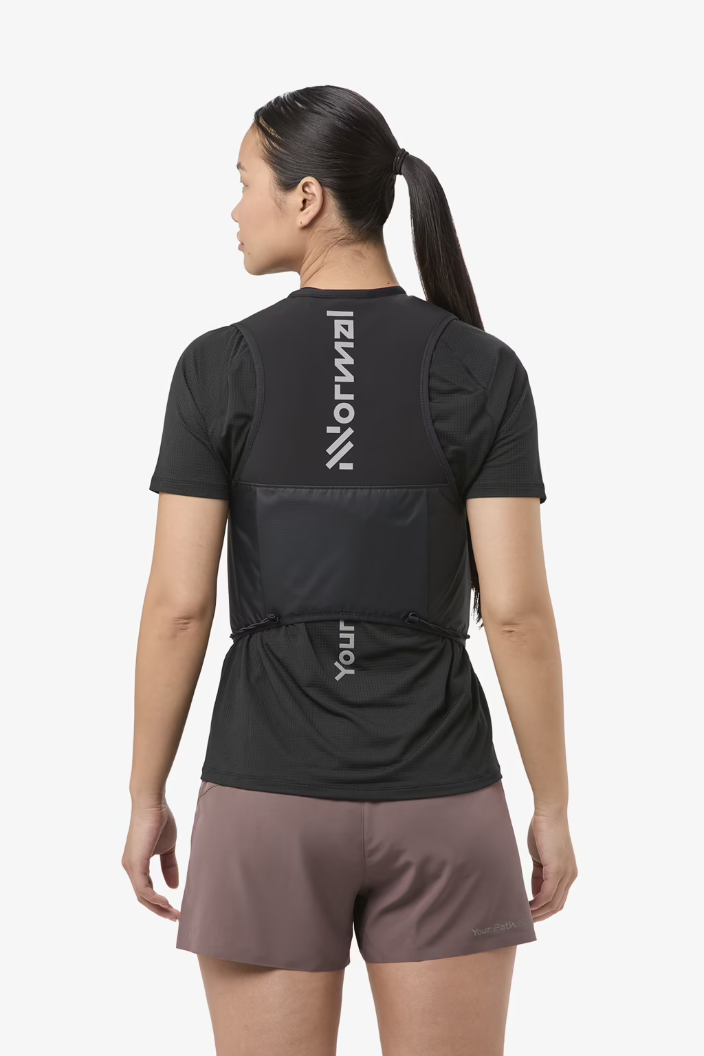 Trail running vest by NNormal with advanced closure, breathable mesh back, and durable elastic flask pockets.