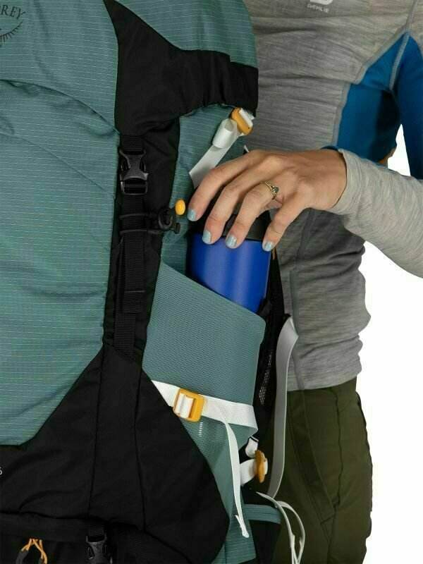 Sirrus 26 backpack with person accessing side pocket for hydration bottle.