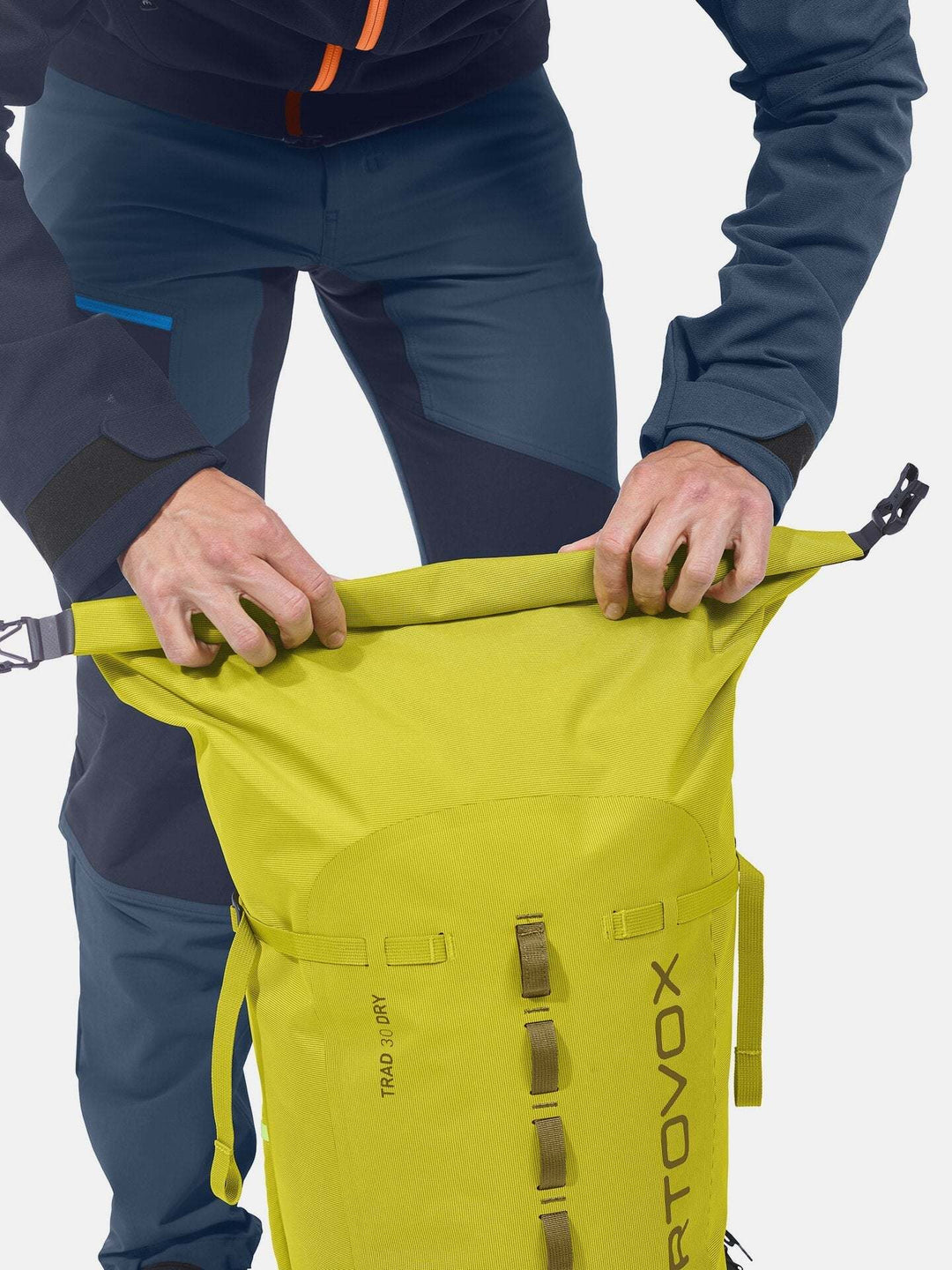 Weather-resistant Trad 30 Dry climbing backpack being rolled shut.
